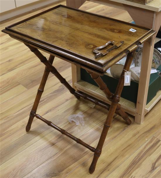 An Indian walnut butlers tray on turned simulated bamboo folding stand, H.68cm